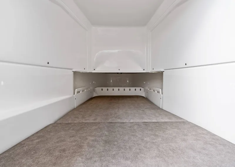 Slide: The Image of Spacious interior of 2025 Solace 32 CS boat, featuring sleek white design and carpeted flooring. - 39