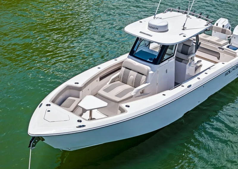 Slide: The Image of 2025 Solace 32 CS boat on clear water, showcasing sleek design and spacious seating. - 4