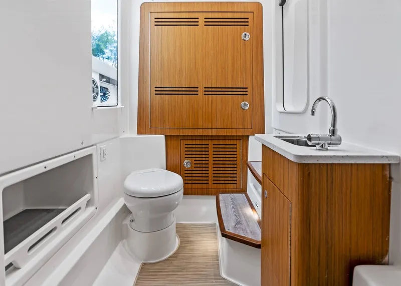 Slide: The Image of Luxurious bathroom interior of 2025 Solace 32 CS boat with wooden cabinetry and modern fixtures. - 40