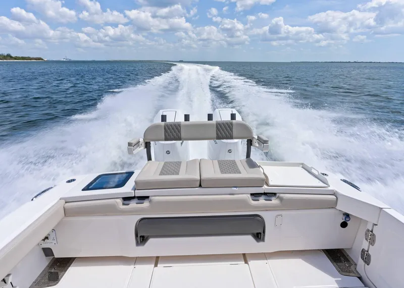 Slide: The Image of 2025 Solace 32 CS boat cruising on open water, leaving a wake behind. - 41