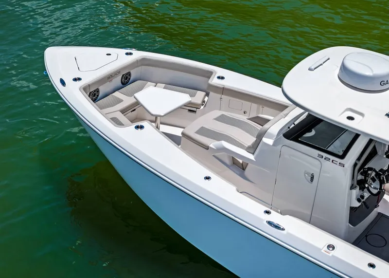 Slide: The Image of 2025 Solace 32 CS boat with sleek design and comfortable seating on calm water. - 5