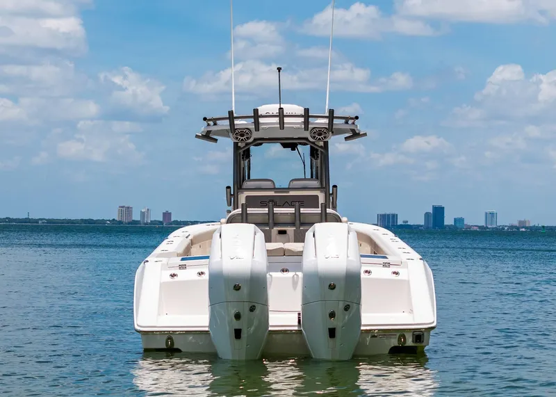 Slide: The Image of 2025 Solace 32 CS boat on calm water with city skyline in background. - 6