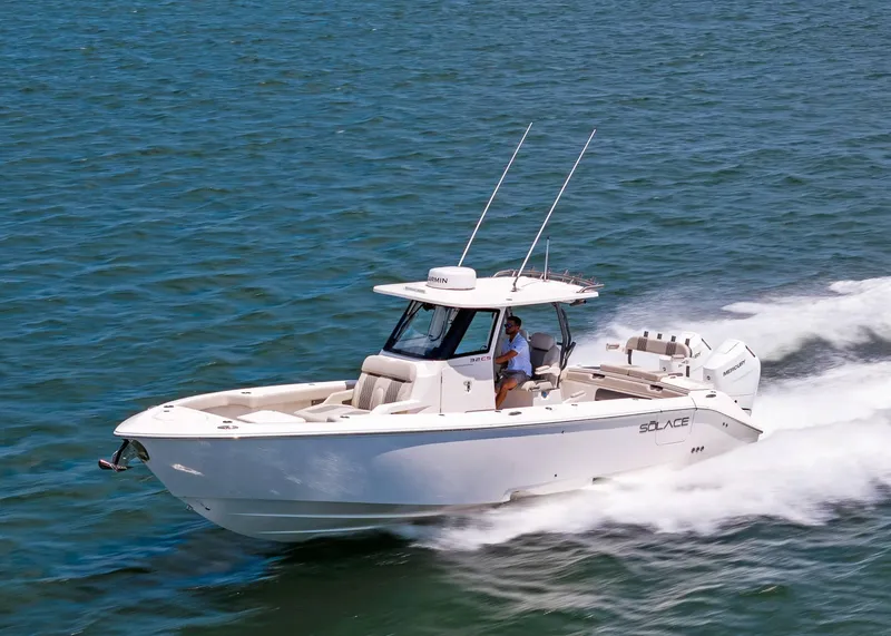 Slide: The Image of 2025 Solace 32 CS boat cruising on open water, showcasing sleek design and performance. - 8