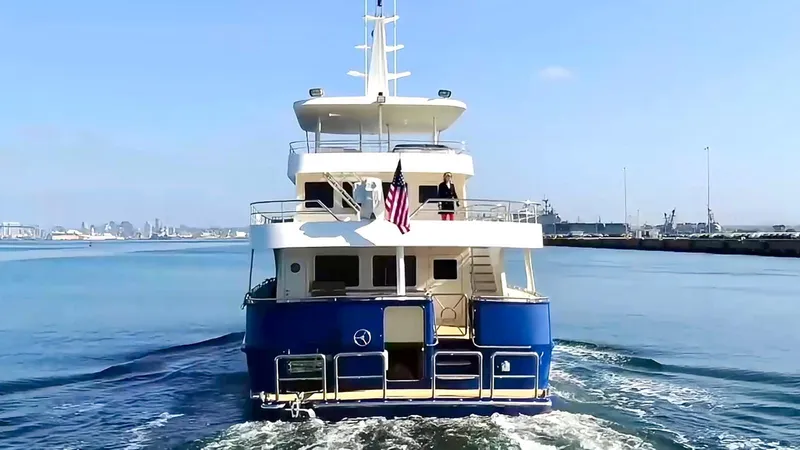 Slide: The Image of Allseas Expedition 2018 yacht cruising in calm waters, rear view with American flag. - 10