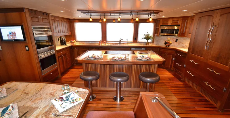 Slide: The Image of Luxurious Allseas Expedition 2018 yacht kitchen with wooden cabinetry and modern appliances. - 14