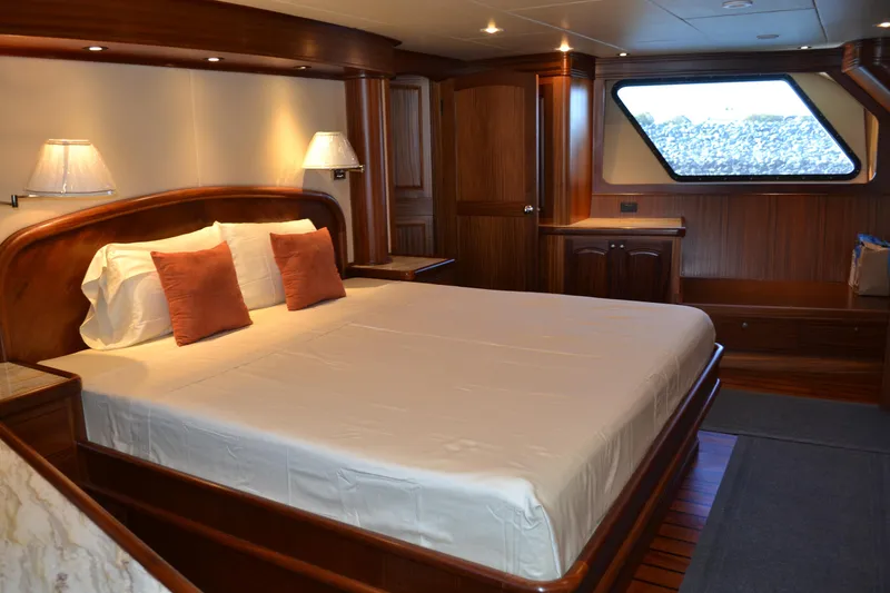 Slide: The Image of Luxurious Allseas Expedition 2018 yacht bedroom with elegant wood finish and large window. - 18