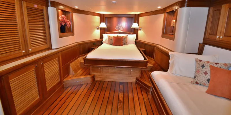 Slide: The Image of Luxurious 2018 Allseas Expedition yacht cabin with wooden interior and cozy bedding. - 21