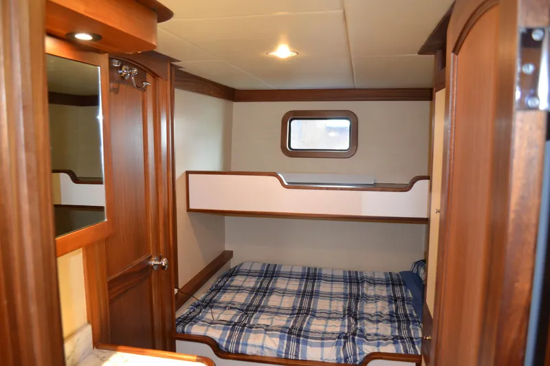 Slide: The Image of Cozy cabin interior of 2018 Allseas Expedition with bunk beds and wooden finish. - 23