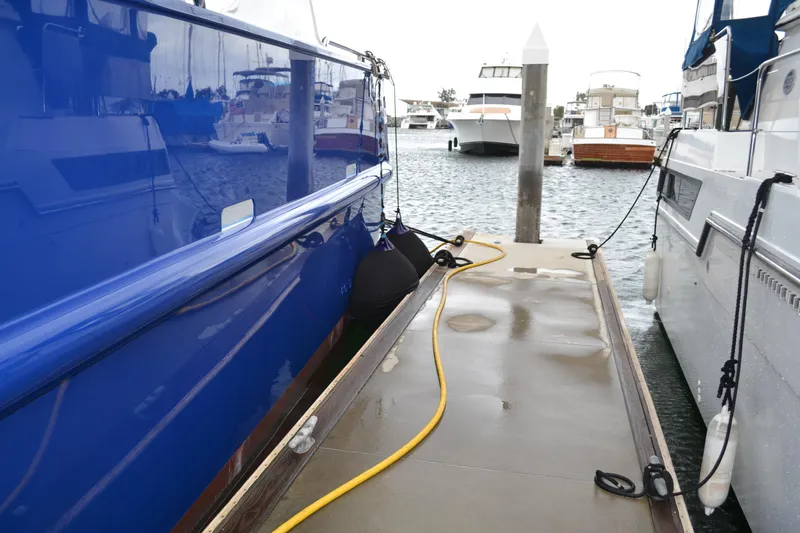 Slide: The Image of Docked Allseas Expedition yacht, 2018 model, with blue hull and marina view. - 37