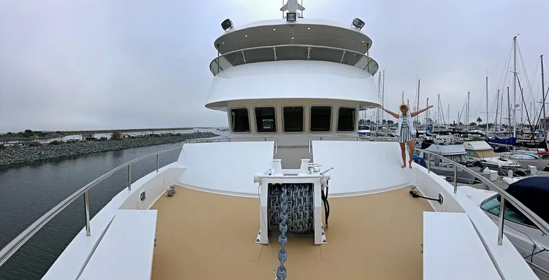 Slide: The Image of 2018 Allseas Expedition yacht deck with person, marina background, overcast sky. - 7