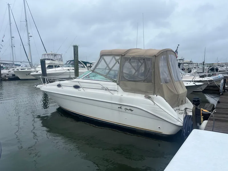 The Image of 1995 Sea Ray 250 Sundancer boat docked at marina on a cloudy day. - 0