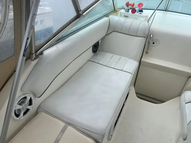 Slide: The Image of Interior seating of 1995 Sea Ray 250 Sundancer boat with white upholstery. - 13