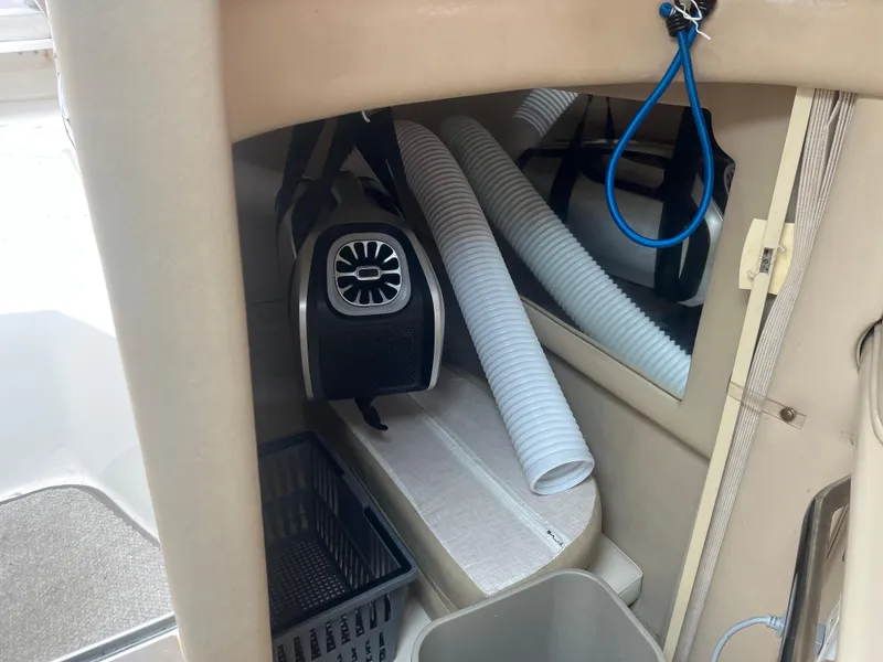 Slide: The Image of 1995 Sea Ray 250 Sundancer cabin interior with ventilation system and storage. - 15