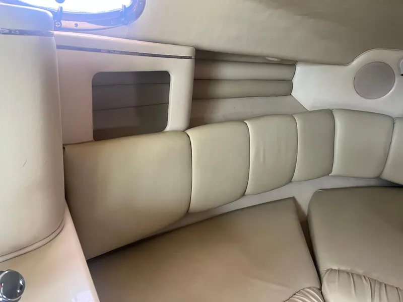 Slide: The Image of Interior of 1995 Sea Ray 250 Sundancer with beige cushioned seating. - 19