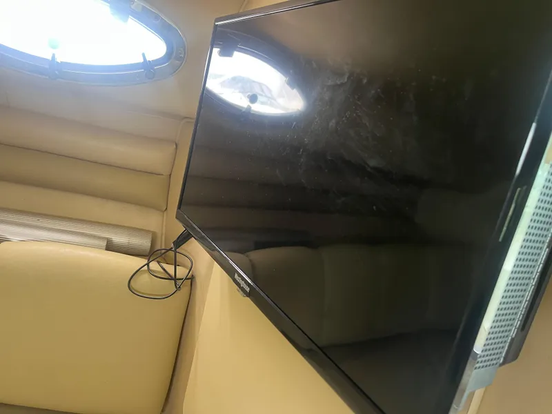 Slide: The Image of Interior of 1995 Sea Ray 250 Sundancer with mounted TV and porthole window. - 20
