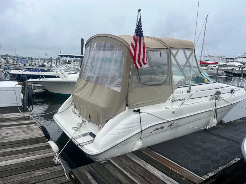 Slide: The Image of 1995 Sea Ray 250 Sundancer docked at marina with American flag. - 4