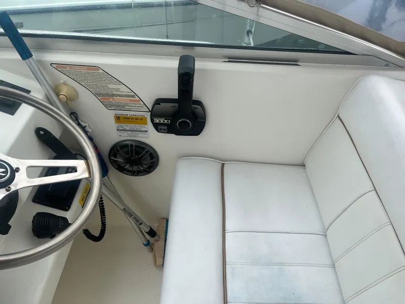 Slide: The Image of Interior of 1995 Sea Ray 250 Sundancer boat with steering wheel and seating. - 6