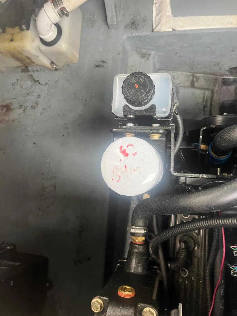 Slide: The Image of Engine compartment of 1995 Sea Ray 250 Sundancer boat, showing mechanical components. - 8