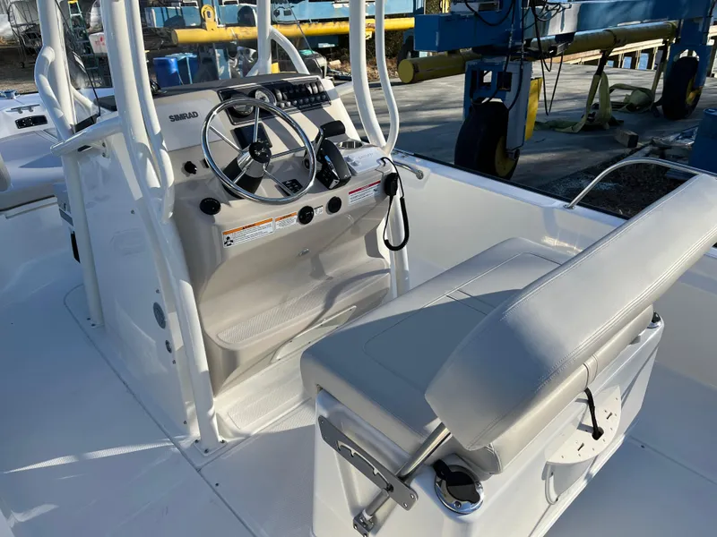 Slide: The Image of 2025 Boston Whaler 210 Montauk boat interior with steering console and seating. - 10