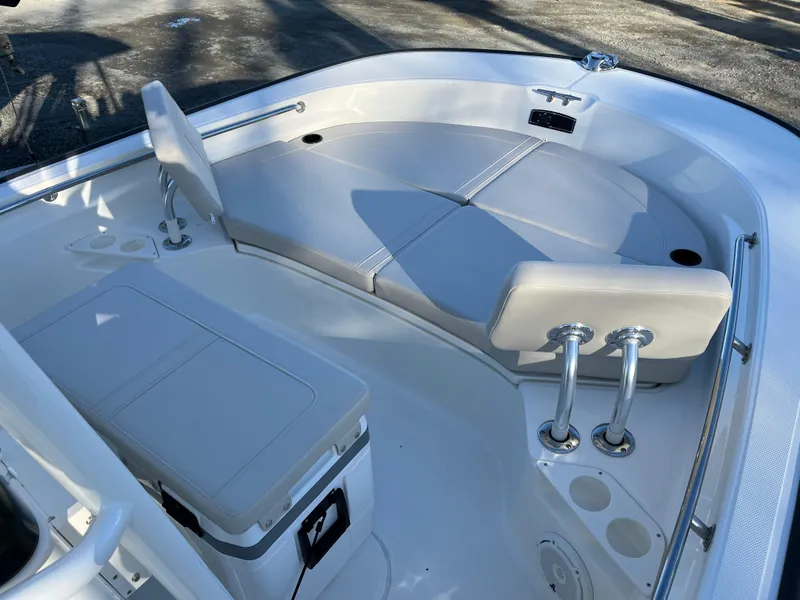 Slide: The Image of 2025 Boston Whaler 210 Montauk boat interior with cushioned seating and storage. - 12