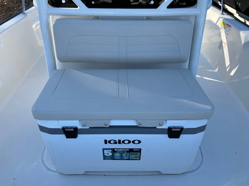 Slide: The Image of Igloo cooler on 2025 Boston Whaler 210 Montauk boat, featuring cushioned seating. - 13