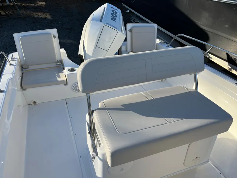 Slide: The Image of 2025 Boston Whaler 210 Montauk boat interior with seating and engine view. - 16