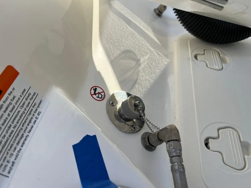 Slide: The Image of 2025 Boston Whaler 210 Montauk boat detail showing fittings and warning label. - 18