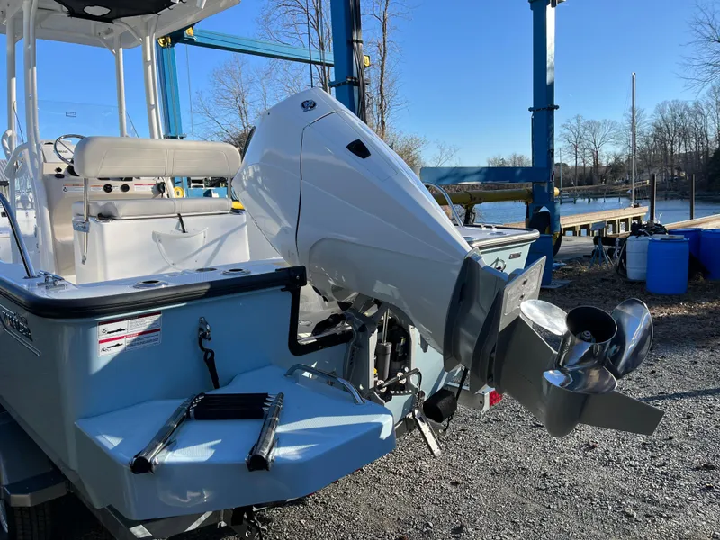 Slide: The Image of 2025 Boston Whaler 210 Montauk boat with outboard motor, docked outdoors. - 22