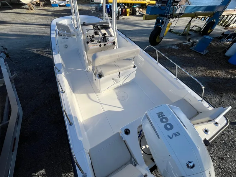 Slide: The Image of 2025 Boston Whaler 210 Montauk boat with 200 V6 engine, docked outdoors. - 5