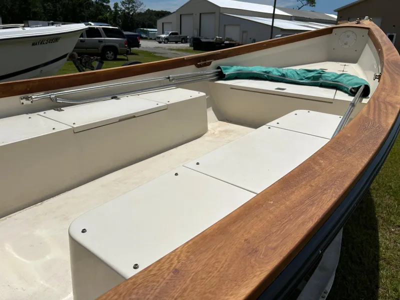 Slide: The Image of 2005 Caribiana Skiff boat interior with wooden trim and storage compartments. - 5