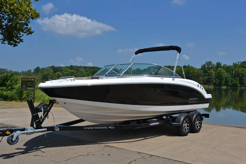 Slide: The Image of 2019 Chaparral 23 H20 boat on trailer by a lake, clear sky background. - 10