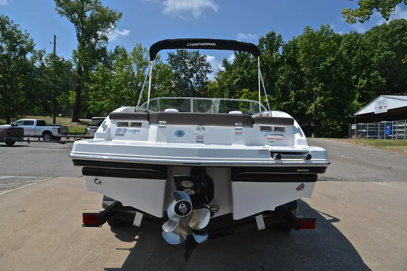 Slide: The Image of 2019 Chaparral 23 H20 boat, rear view, parked on trailer, sunny day. - 13