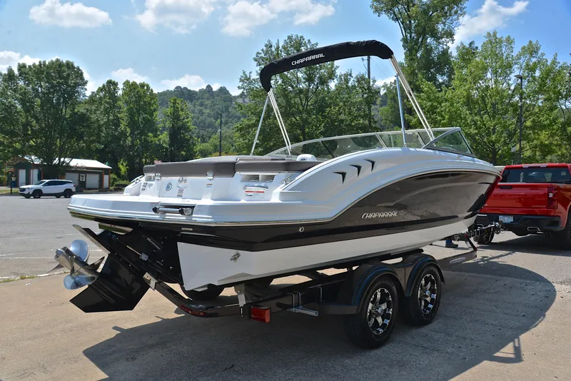 Slide: The Image of 2019 Chaparral 23 H20 boat on trailer, parked outdoors. - 14