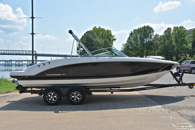 Slide: The Image of 2019 Chaparral 23 H20 boat on trailer by a lakeside. - 15