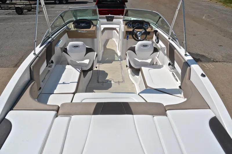 Slide: The Image of 2019 Chaparral 23 H20 boat interior with white seating and modern dashboard. - 18