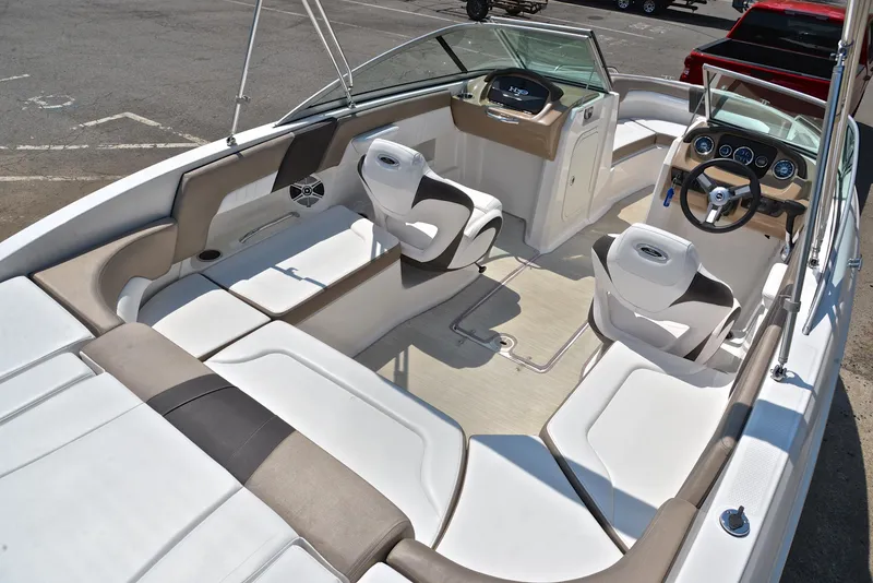 Slide: The Image of 2019 Chaparral 23 H20 boat interior with seating and steering wheel. - 19