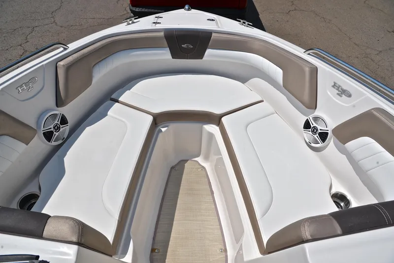 Slide: The Image of 2019 Chaparral 23 H20 boat interior with cushioned seating and speakers. - 21