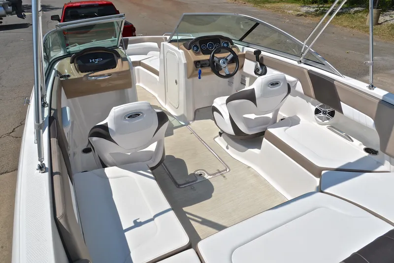 Slide: The Image of 2019 Chaparral 23 H20 boat interior with white seating and modern dashboard. - 23