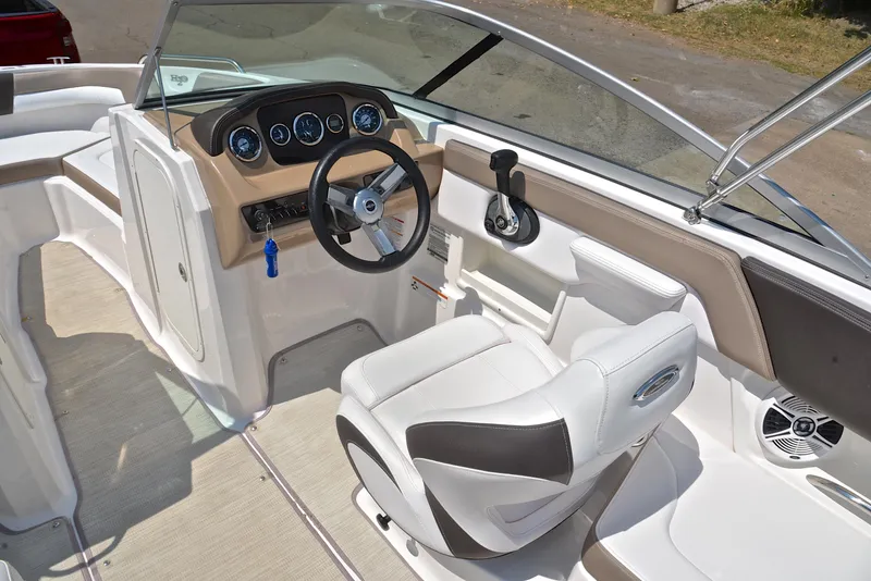 Slide: The Image of 2019 Chaparral 23 H20 boat interior with steering wheel and dashboard controls. - 24
