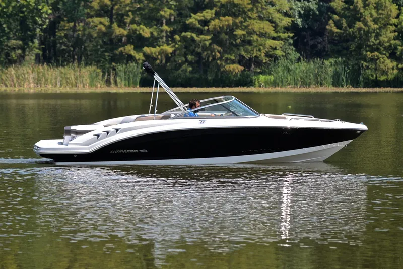 Slide: The Image of 2019 Chaparral 23 H20 boat cruising on a calm lake. - 7