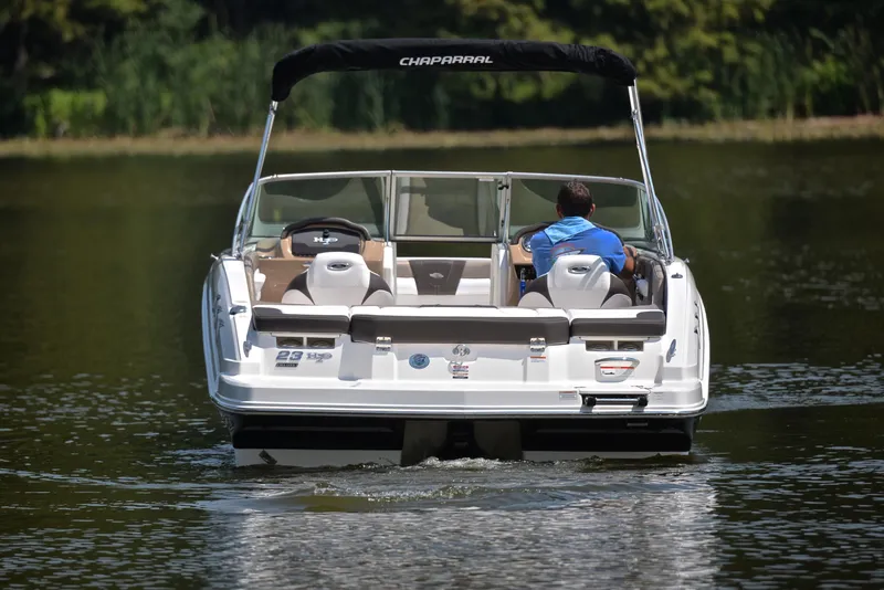 Slide: The Image of 2019 Chaparral 23 H20 boat cruising on a calm lake. - 8