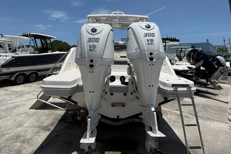 Slide: The Image of 2024 Robalo R317 Dual Console with twin 300 V6 outboard engines, docked outdoors. - 18