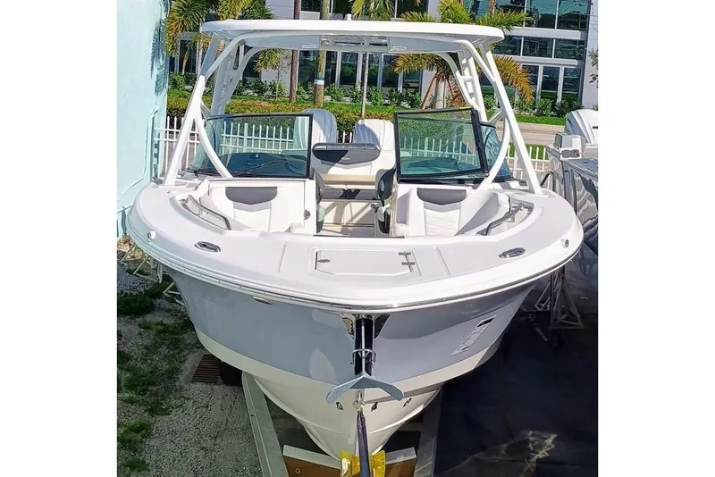 Slide: The Image of 2024 Robalo R317 Dual Console boat, front view, docked outdoors. - 2