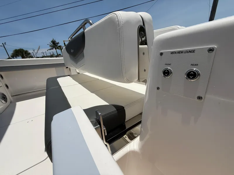 Slide: The Image of 2024 Robalo R317 Dual Console boat interior with adjustable seating and control panel. - 7
