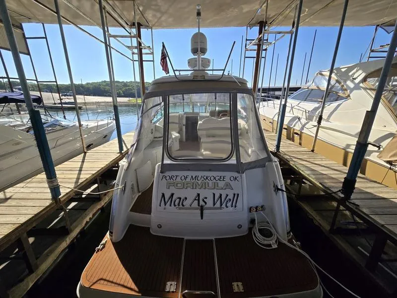 Slide: The Image of 2008 Formula 37 PC yacht docked at marina, rear view with name "Mae As Well." - 13