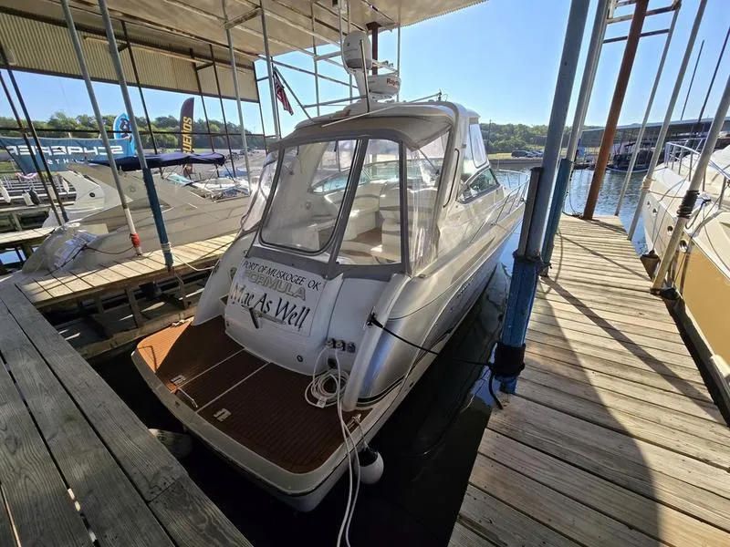 Slide: The Image of 2008 Formula 37 PC boat docked in a marina under a covered slip. - 14