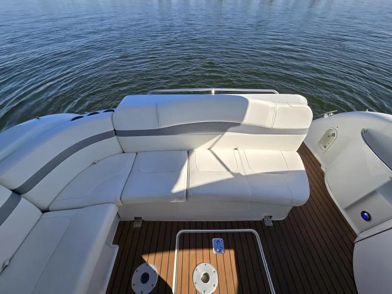 Slide: The Image of 2008 Formula 37 PC boat with white seating and wooden deck on calm water. - 23