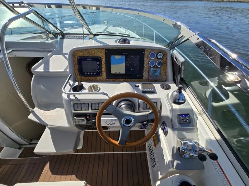 Slide: The Image of Cockpit of 2008 Formula 37 PC yacht with navigation controls and wooden steering wheel. - 27