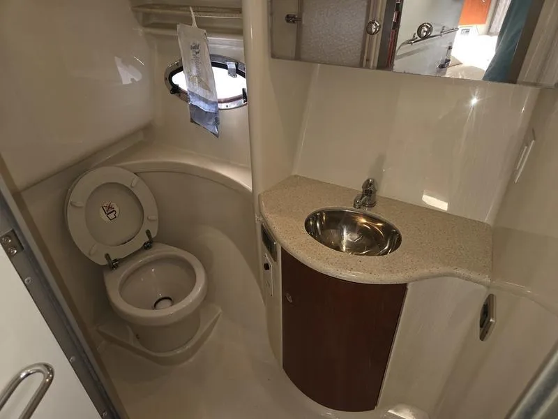 Slide: The Image of 2008 Formula 37 PC yacht bathroom with toilet, sink, and porthole window. - 30