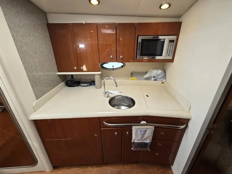 Slide: The Image of 2008 Formula 37 PC yacht kitchen with wood cabinets, sink, and microwave. - 31